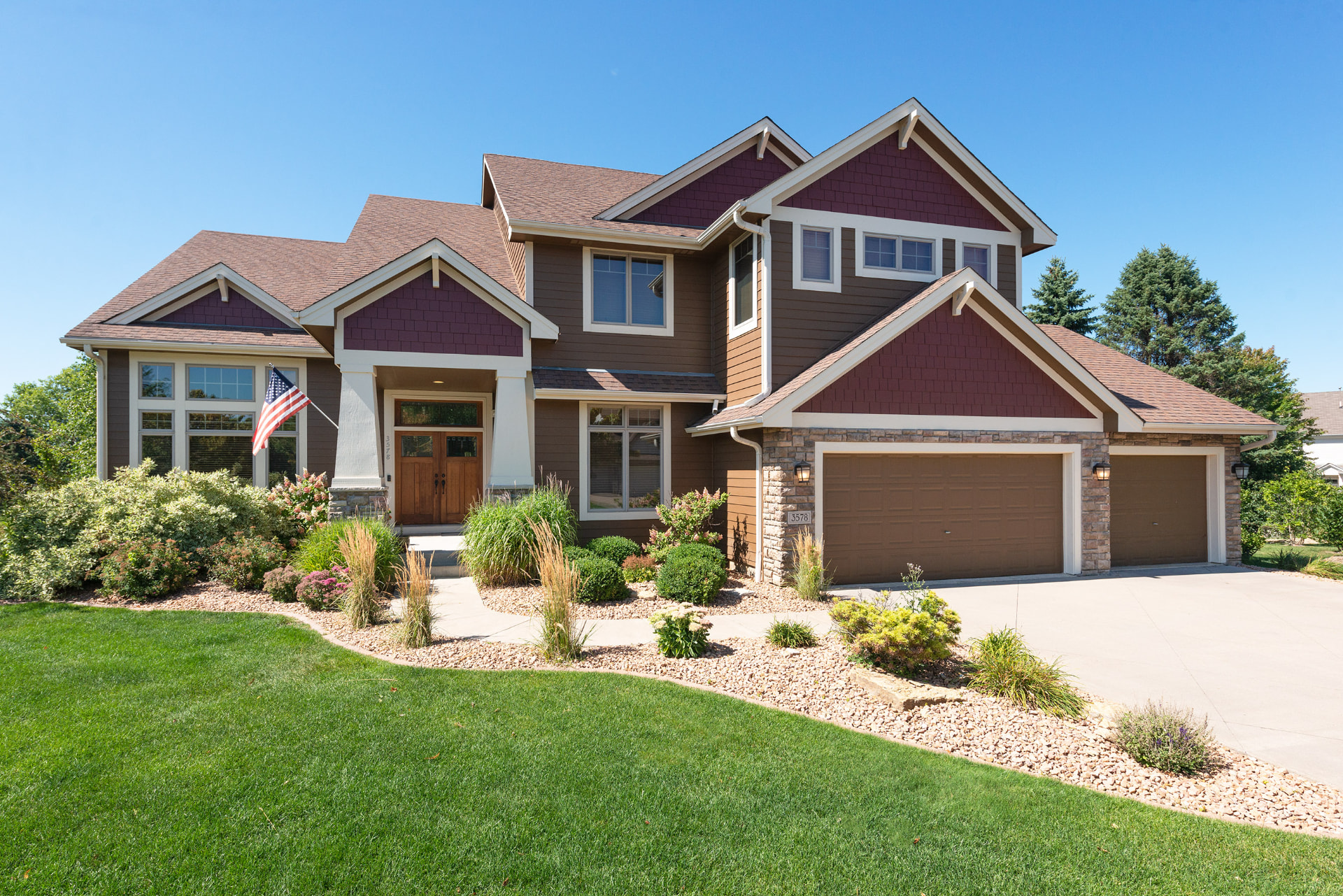 A large two story home with stone accents and a three car garage in Woodbury, Minnesota, listed and sold by Jason Lange
