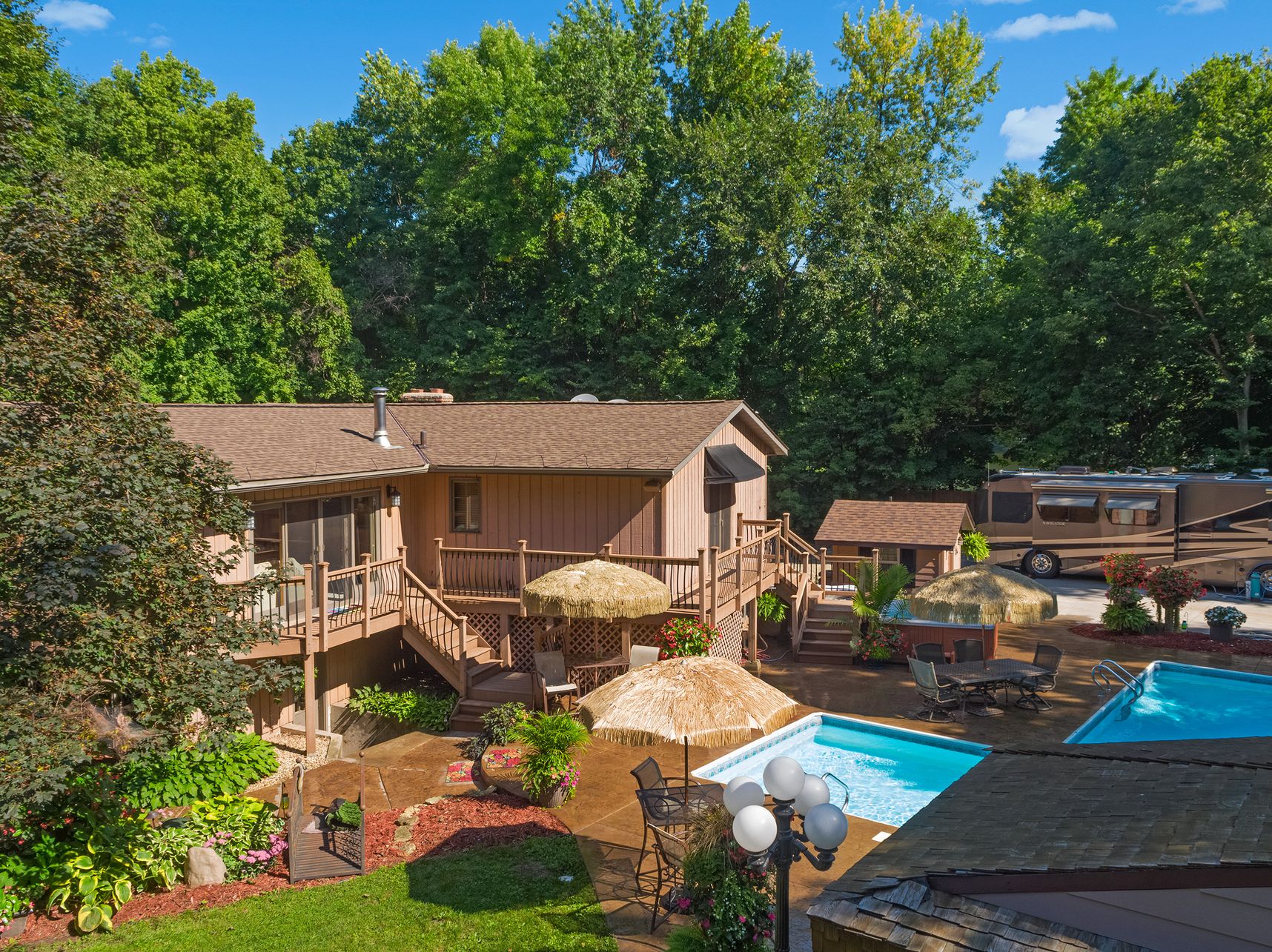 Backyard at 10651 Grey Cloud Trail S, Cottage Grove: walkout home with deck, heated in-ground pool, patio and motorhome pad